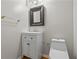 Elegant half-bathroom featuring modern fixtures, a vanity, and a decorative mirror at 1048 Falls Brooke Dr, Conyers, GA 30094