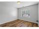 Neutral bedroom featuring a window for natural light and laminate floors at 1048 Falls Brooke Dr, Conyers, GA 30094