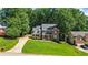 Classic brick home with manicured lawn, mature trees, and inviting front porch at 1048 Falls Brooke Dr, Conyers, GA 30094