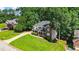 Well-maintained home featuring lush greenery and a long driveway on a hill at 1048 Falls Brooke Dr, Conyers, GA 30094