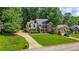 Charming brick home with a large, landscaped front yard and long driveway at 1048 Falls Brooke Dr, Conyers, GA 30094