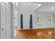Bright foyer with hardwood floors, white walls, and a high ceiling with large windows at 1048 Falls Brooke Dr, Conyers, GA 30094