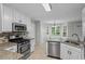 Modern kitchen with stainless steel appliances, granite countertops, and ample cabinet space at 1048 Falls Brooke Dr, Conyers, GA 30094