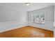 Inviting living room with natural light, hardwood floors, and neutral paint at 1048 Falls Brooke Dr, Conyers, GA 30094
