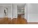 Cozy living room featuring hardwood floors and neutral color palette with views of the kitchen at 1048 Falls Brooke Dr, Conyers, GA 30094