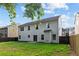 Backyard with the property's siding, patio, privacy fence, and mature trees at 1137 Misty Valley Ct, Lawrenceville, GA 30045