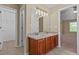 Bathroom with double sinks, ample counter space, and access to other rooms at 1137 Misty Valley Ct, Lawrenceville, GA 30045