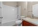 Full bathroom showcasing a shower-tub combo, vanity, and tile flooring at 1137 Misty Valley Ct, Lawrenceville, GA 30045