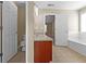 Bathroom featuring vanity, toilet, tub, and access to bedroom and closet at 1137 Misty Valley Ct, Lawrenceville, GA 30045