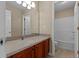 Bathroom featuring a large mirror, granite countertops, and a shower-tub combo at 1137 Misty Valley Ct, Lawrenceville, GA 30045