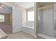 Well-lit bathroom with a shower stall and separate soaking tub at 1137 Misty Valley Ct, Lawrenceville, GA 30045