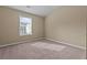 Cozy bedroom with plush carpeting, a window offering natural light, and neutral-toned walls at 1137 Misty Valley Ct, Lawrenceville, GA 30045