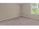 Bright bedroom featuring plush carpeting, neutral-toned walls, and a window with natural light at 1137 Misty Valley Ct, Lawrenceville, GA 30045