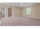 Spacious bedroom with neutral walls, plush carpeting, and ample natural light from the window at 1137 Misty Valley Ct, Lawrenceville, GA 30045
