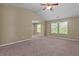 Large bedroom with windows and neutral-toned walls and carpet at 1137 Misty Valley Ct, Lawrenceville, GA 30045