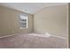 Bedroom featuring plush carpeting, neutral-toned walls, and a window offering natural light at 1137 Misty Valley Ct, Lawrenceville, GA 30045