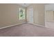 Bedroom featuring plush carpeting, neutral-toned walls, and a window offering natural light at 1137 Misty Valley Ct, Lawrenceville, GA 30045