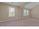 Bedroom featuring carpeted floors, two windows, and arched ceiling at 1137 Misty Valley Ct, Lawrenceville, GA 30045