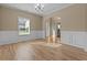 Bright dining room with hardwood floors, wainscotting, and elegant chandelier at 1137 Misty Valley Ct, Lawrenceville, GA 30045