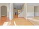 Bright foyer with hardwood floors, staircase, and a glimpse into the living room featuring a fireplace at 1137 Misty Valley Ct, Lawrenceville, GA 30045