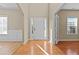 Bright foyer with hardwood floors, white wainscoting, and a front door flanked by sidelight windows at 1137 Misty Valley Ct, Lawrenceville, GA 30045