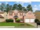 Charming two-story brick home with red shutters, lush green lawn, and a two-car garage at 1137 Misty Valley Ct, Lawrenceville, GA 30045
