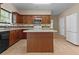 Kitchen with a center island, dark wood cabinets, tile backsplash, and a white refrigerator at 1137 Misty Valley Ct, Lawrenceville, GA 30045