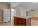 Open-concept kitchen with island and white refrigerator at 1137 Misty Valley Ct, Lawrenceville, GA 30045