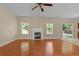Spacious living room featuring a fireplace, windows, and a sliding glass door to the backyard at 1137 Misty Valley Ct, Lawrenceville, GA 30045