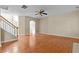 Bright living room with gleaming hardwood floors, neutral paint, and a ceiling fan at 1137 Misty Valley Ct, Lawrenceville, GA 30045
