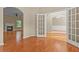Living space with hardwood floors, an archway entrance, and view into the living room with a fireplace at 1137 Misty Valley Ct, Lawrenceville, GA 30045