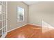 Bright home office with hardwood floors, a large window with blinds, and glass paneled doors at 1137 Misty Valley Ct, Lawrenceville, GA 30045