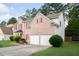 Brick home featuring well-maintained landscaping and a two-car garage with driveway at 1137 Misty Valley Ct, Lawrenceville, GA 30045