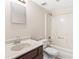 Bathroom features a tub-shower, toilet, and sink with dark wood cabinets at 124 Camelot Dr, Atlanta, GA 30349