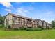 Charming condo with brick facade and Tudor-style accents surrounded by a lush green lawn at 124 Camelot Dr, Atlanta, GA 30349