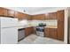 Traditional kitchen with stainless steel appliances and wood cabinets at 124 Camelot Dr, Atlanta, GA 30349