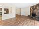 Open floor plan living room featuring wood laminate floors and stone fireplace at 124 Camelot Dr, Atlanta, GA 30349