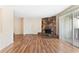 Spacious living room with laminate floors and a cozy stone fireplace at 124 Camelot Dr, Atlanta, GA 30349