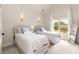 Bright bedroom features two beds with blue accents, a window, and a full length mirror at 2230 Cambridge Hill Ct, Dacula, GA 30019