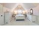 Elegant bedroom features a pitched ceiling, chandelier, and beautiful matching dressers at 2230 Cambridge Hill Ct, Dacula, GA 30019