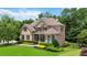 Charming two-story home features a combination of brick and stone, lush landscaping, and a well-manicured lawn at 2230 Cambridge Hill Ct, Dacula, GA 30019