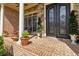Close-up of the brick porch with a beautiful metal and glass front door at 2230 Cambridge Hill Ct, Dacula, GA 30019