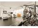Spacious home gym with various exercise equipment, including a treadmill and weight rack at 2230 Cambridge Hill Ct, Dacula, GA 30019