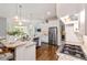Bright open-concept kitchen featuring an island, stainless appliances, and hardwood floors at 2230 Cambridge Hill Ct, Dacula, GA 30019