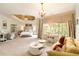 Expansive main bedroom with sitting area, tray ceiling, and abundant natural light at 2230 Cambridge Hill Ct, Dacula, GA 30019
