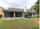 Well-maintained backyard featuring a sunroom with lots of windows at 550 Sessingham Ct, Alpharetta, GA 30005