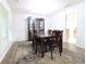 Formal dining room with wood floors, a dark wood dining table, and a china cabinet at 550 Sessingham Ct, Alpharetta, GA 30005