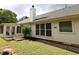 Well-maintained backyard with a sunroom and mature landscaping at 550 Sessingham Ct, Alpharetta, GA 30005