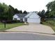 Charming one-story home featuring a well-maintained lawn and a paved driveway leading to an attached garage at 550 Sessingham Ct, Alpharetta, GA 30005