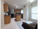 Open-concept kitchen featuring stainless steel appliances and center island at 550 Sessingham Ct, Alpharetta, GA 30005
